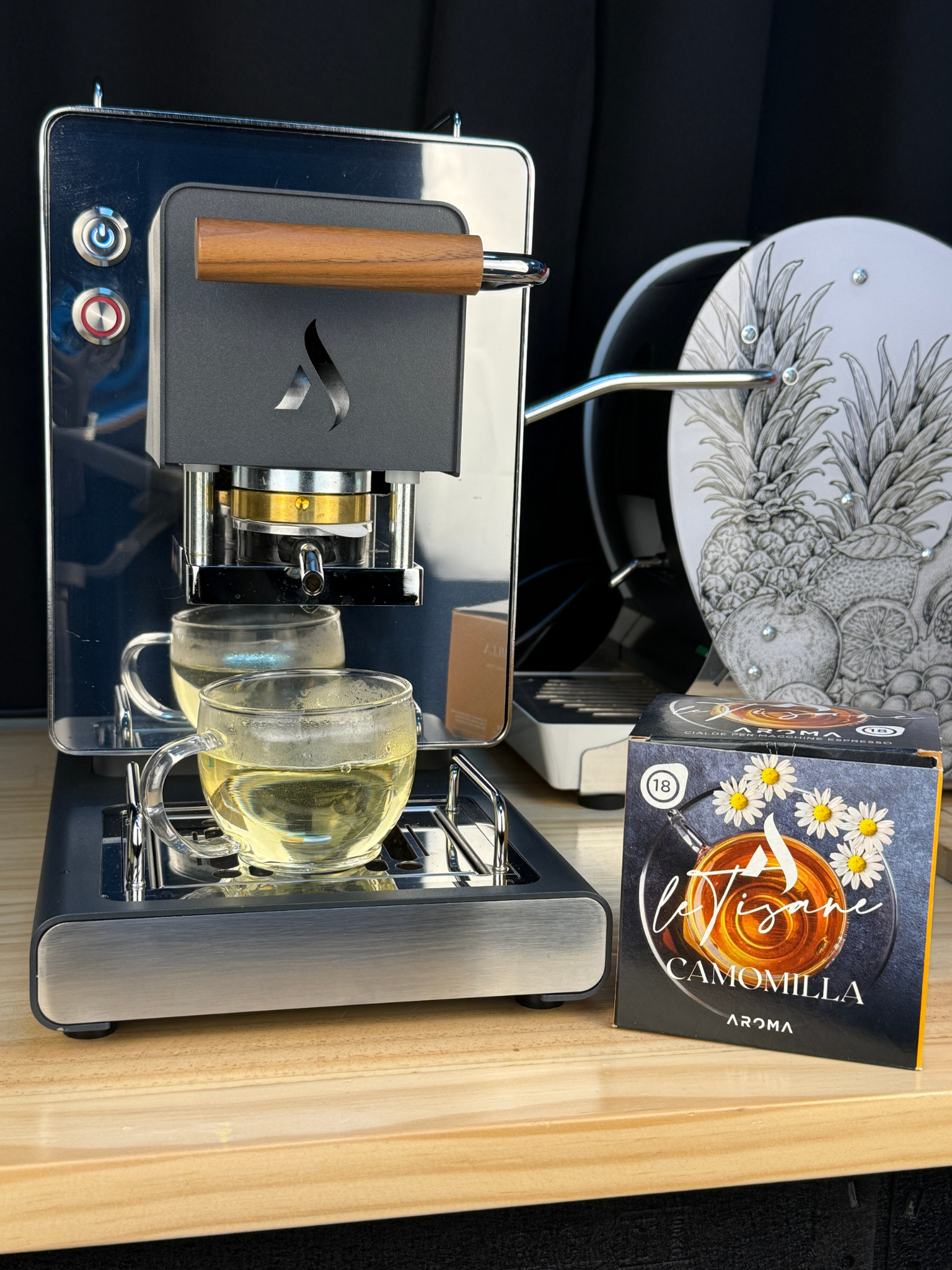 Camomilla aroma ESE tea pods box, dark packaging with daisies and handwritten-style logo