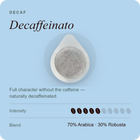Decaffeinated coffee pod with gray grounds in a white capsule