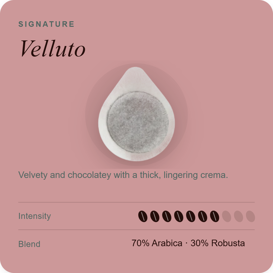 Coffee pod with white outer capsule and dark gray coffee grounds filling