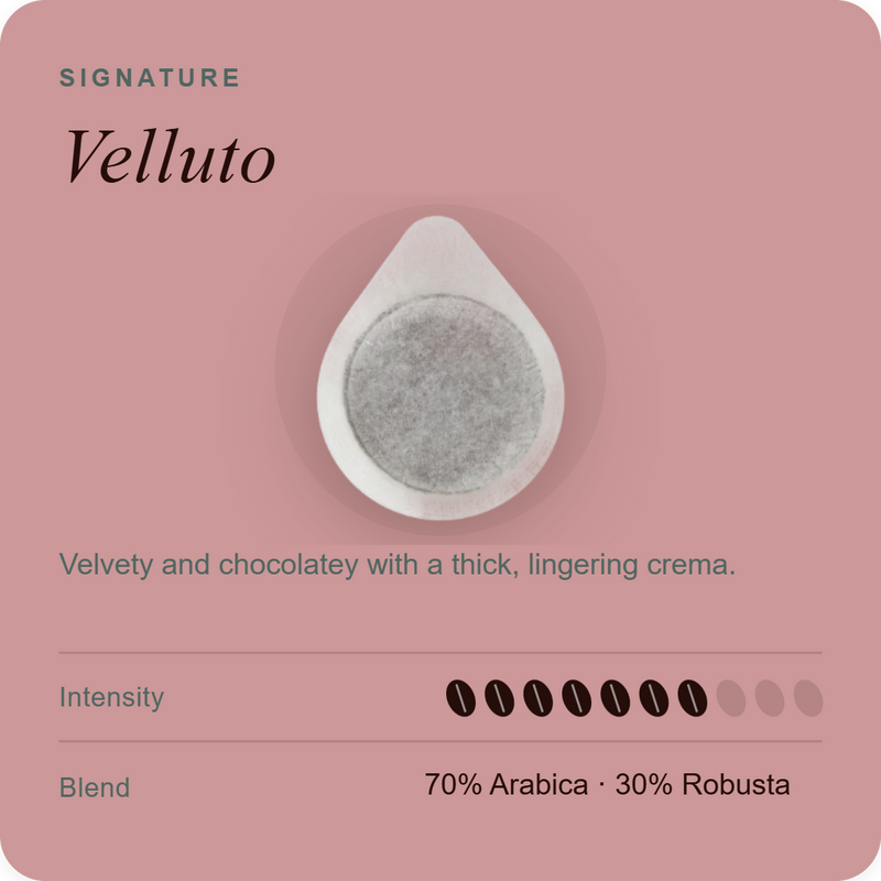 Coffee pod with white outer capsule and dark gray coffee grounds filling