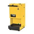 Yellow coffee pod machine with front pod window and drip tray grate, side spout bar.