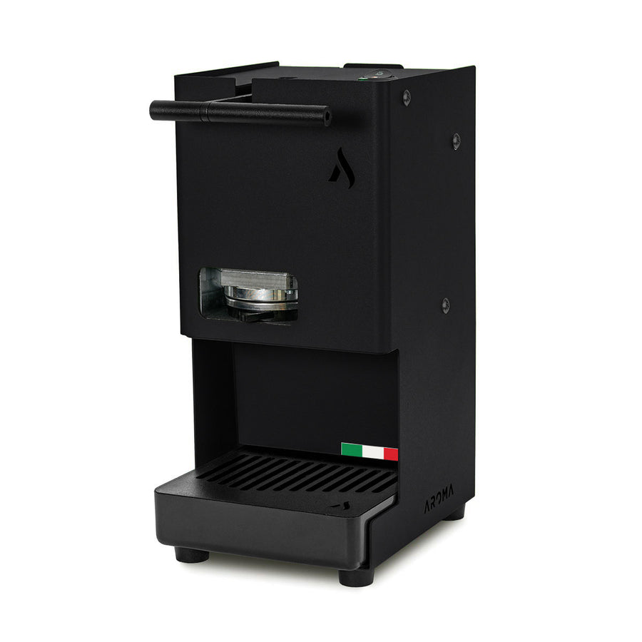 Black coffee pod machine with front pod window and drip tray grate, side spout bar.