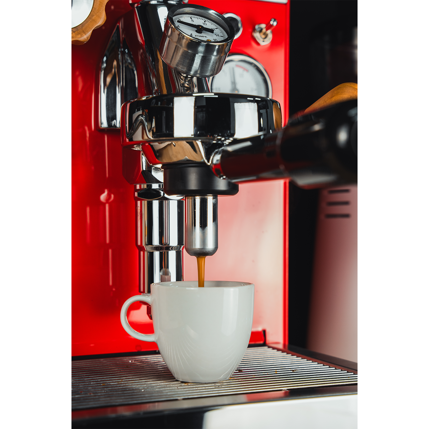 Chrome espresso ESE pod handle with metal basket attached to the machine group