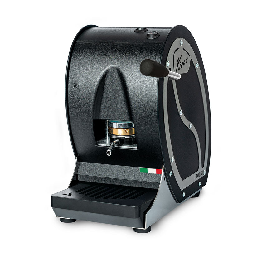 Black pod coffee machine with side door, drip tray, and dispensing spout