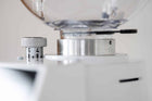 Close-up of coffee grinder interior with adjustment ring and measurement markings