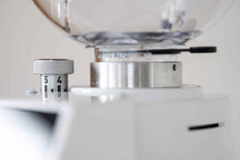 Close-up of coffee grinder interior with adjustment ring and measurement markings