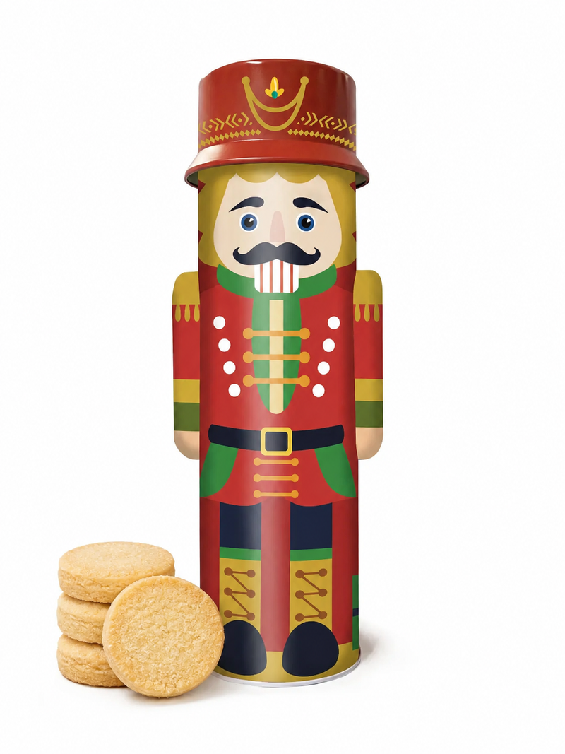 Nutcracker biscuit tin with red-and-green soldier design, with shortbread cookies beside