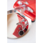 Red coffee grinder close-up of metal chute and side outlet