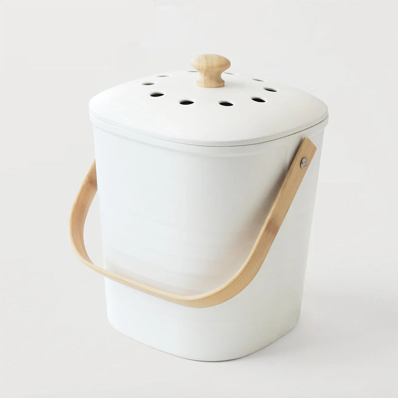 Lightweight bench-top compost bin with white lid, wooden carry handle, and vent holes