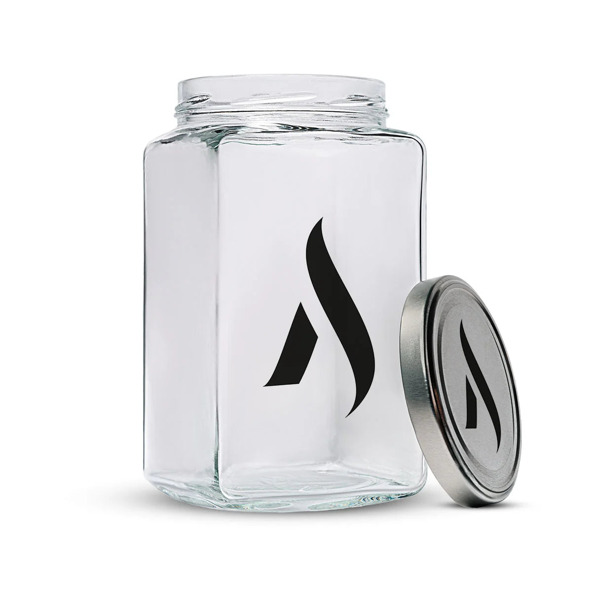 IXELLE glass jar with flame logo and matching metal lid, angled view