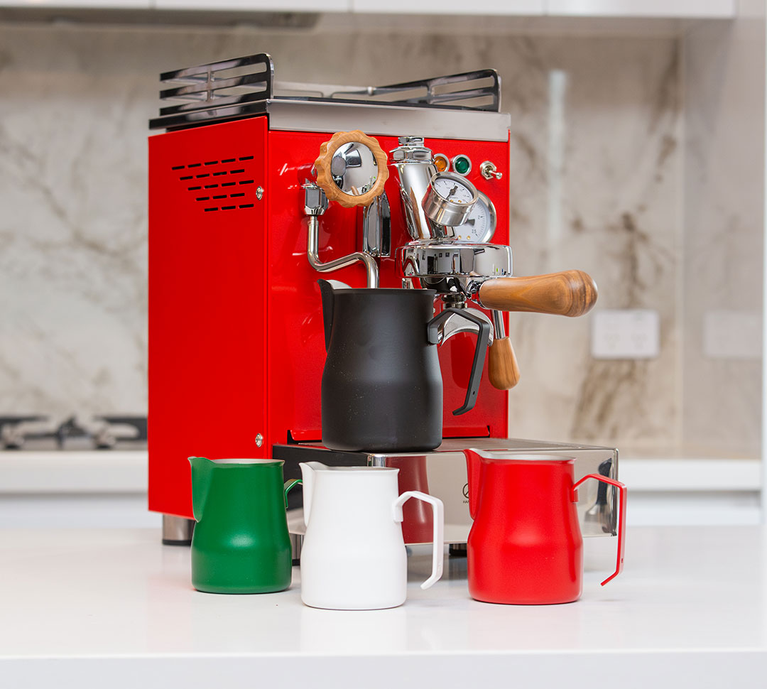 Milk jugs display with black, green, white, and red jugs and curved handles