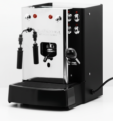 Black and stainless steel pod coffee machine with two spouts and controls