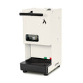 White coffee pod machine with front pod window and drip tray grate, side spout bar.