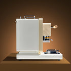 White coffee pod machine with wooden side handle and drip tray