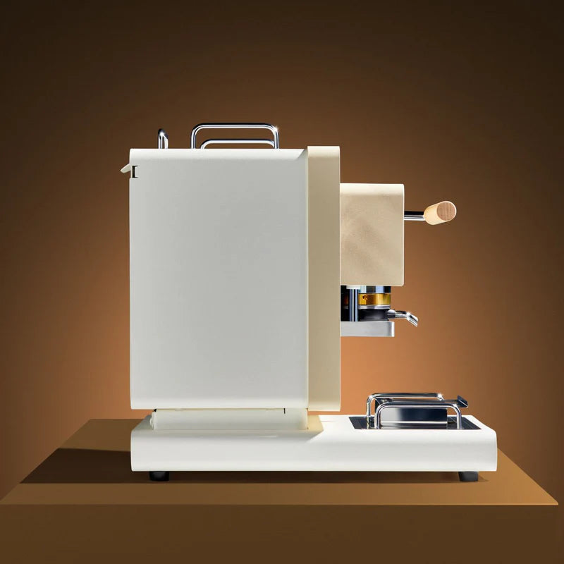 White coffee pod machine with wooden side handle and drip tray