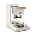 White coffee pod machine with wooden handle, front brew chamber, and metal drip tray