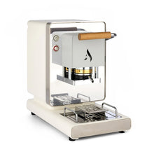 White coffee pod machine with wooden handle, front brew chamber, and metal drip tray