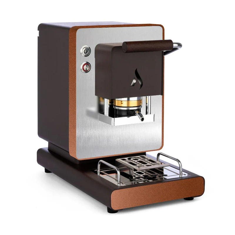 Dark brown coffee pod machine with wooden handle, front brew chamber, and drip tray
