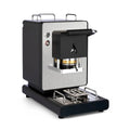 Matte black and silver coffee pod machine with wooden handle and front brew chamber
