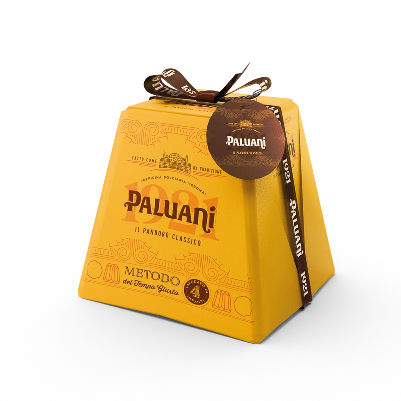 Yellow hand-wrapped pandoro gift box with Paluani label and ribbon bow
