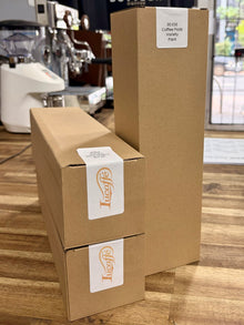 Lucaffe coffee pod pack shipping cartons, tall brown box with 30 pods labels